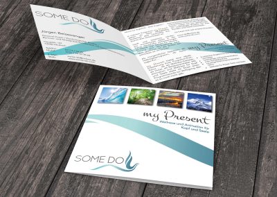 4page flyer lying on wooden floor
